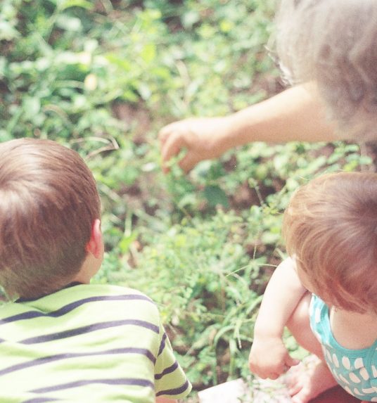 Intergenerational senior interacting with young children